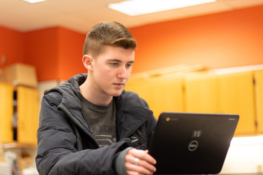Senior Carson McCarver works on a Google Chromebook in his Physics C: Electricity and Magnetism class. McCarver received the National Merit Finalist designation on Feb. 13.