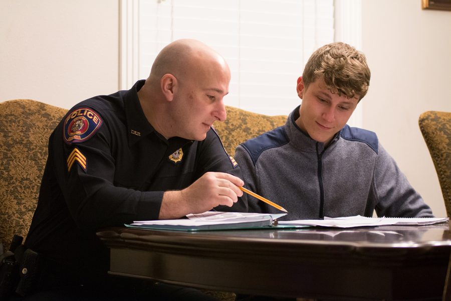 Texarkana, Arkansas Sgt. Jeremy Gordon helps senior Garret Burks with his homework as part of the Police Mentoring Program. Some believe that police officers are misunderstood and stereotyped. 