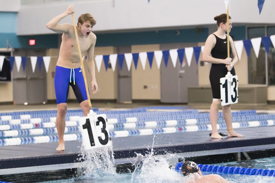 Senior Dylan Rosser counts senior Brady Moore’s laps in the 500 freestyle while cheering him on. The regional meet took place in Lewisville and was wildly successful for the Tigersharks. ”The meet went very well, and the majority of us qualified for state. I couldnt have asked for a better finale, winning all my events and watching my other seniors qualifying for state,” Rosser said.