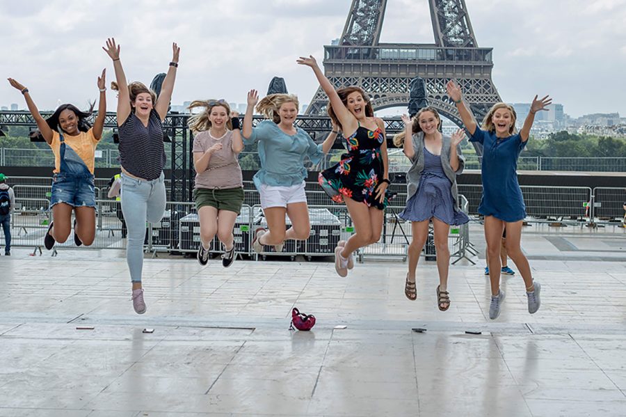 Several junior girls jump in front of the Eiffel Tower in Paris, France. A group of students visited various European countries in summer 2018.