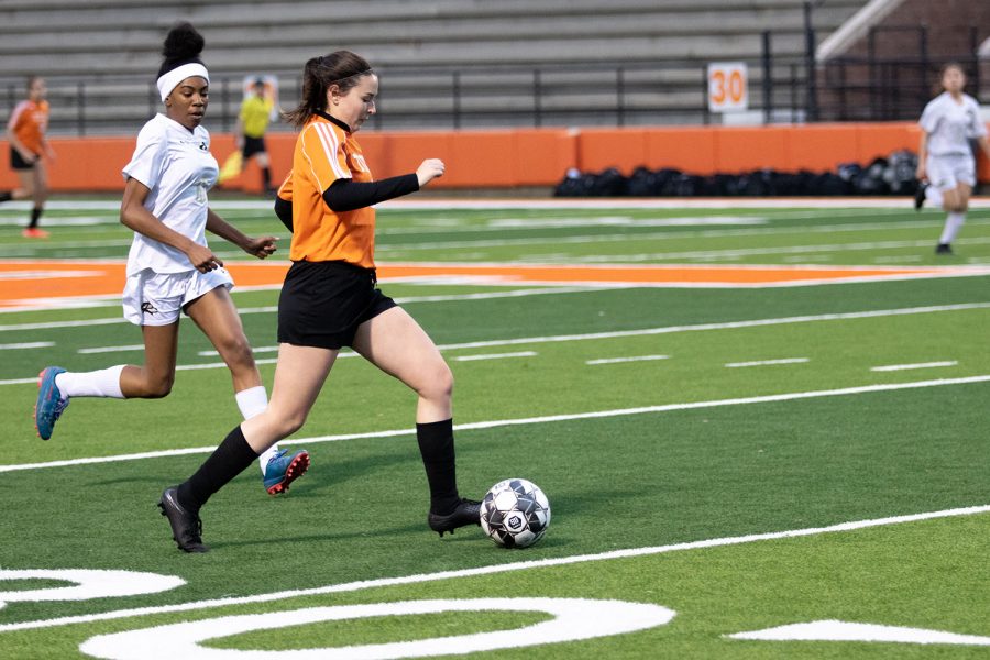 Traveling across the soccer field, sophomore Megan Dineen dribbles down the sideline. The Lady Tigers played against Sulphur Springs. 