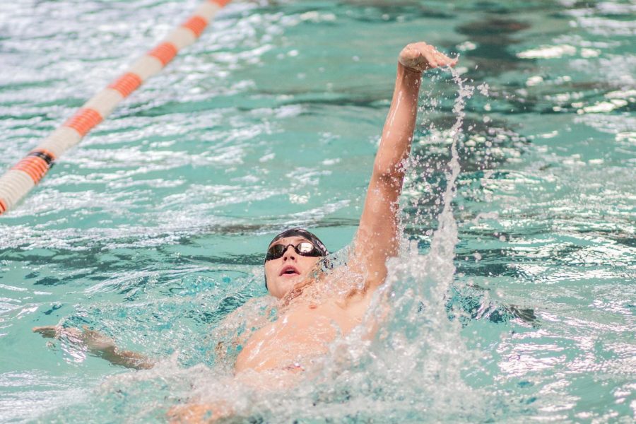 Senior+Dylan+Rosser+backstrokes+at+the+orange+black+and+white+swim+meet.+Rosser+has+been+a+swimmer+for+the+past+six+years.+