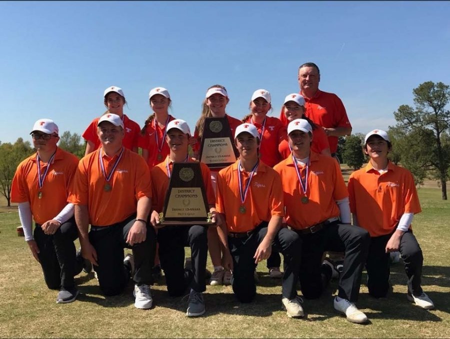 Golf coach Jay Brewer stands with members of the Texas High golf team after a team victory.