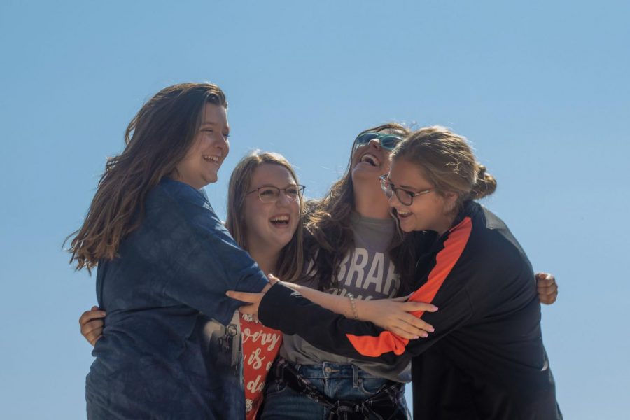 A group of Texarkana teens embrace each other while laughing. They can now hangout without having to worry about doing the same activities.