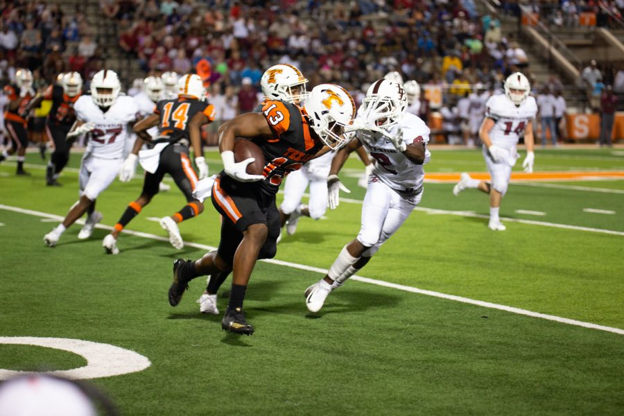 Kobe Webster stiff arms a Liberty Eyalu defender in the 62-13 victory against the cross town rival. The Tigers improved their record to 2-1 on the season and will travel to Kilgore next week.