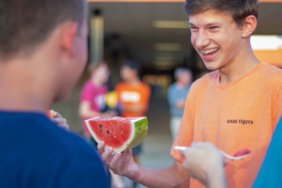 Texas High sophomore Spencer Lawing laughs with friends at the Watermelon Supper. The Watermelon Supper gave students a way to bond at Texas High School.