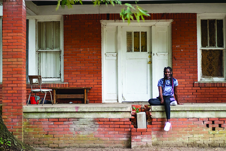 Sitting outside her home in Beverly, junior Dashanae Criner reflects on how she has overcome the time she spent in a homeless shelter and being bullied. “I went from thinking I was worthless in the world to  thinking I probably do have a purpose in the world,” Criner said.