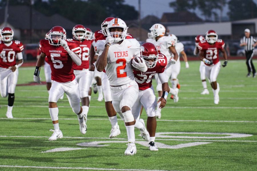 Senior Tracy Cooper outruns the Arkansas Razorback defense to score a touchdown in the second quarter of the 2019 Texas High vs. Arkansas High game. The Tigers held the Razorbacks to only seven points in the game.