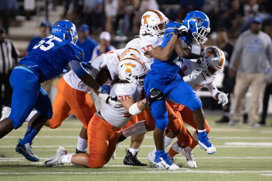 Texas Highs defenders Devaughante Jack (30) and Clayton Smith (10) attempt to bring down the running back from John Tyler September 27, 2019. The Tigers lost their district opener 16-0.