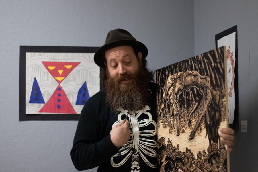 On Oct. 25, artist Neal Harrington explains a print he created to the Texas High Art Club. Harringtons work is currently displayed downtown in the gallery at the Texarkana Regional Arts and Humanities Council.