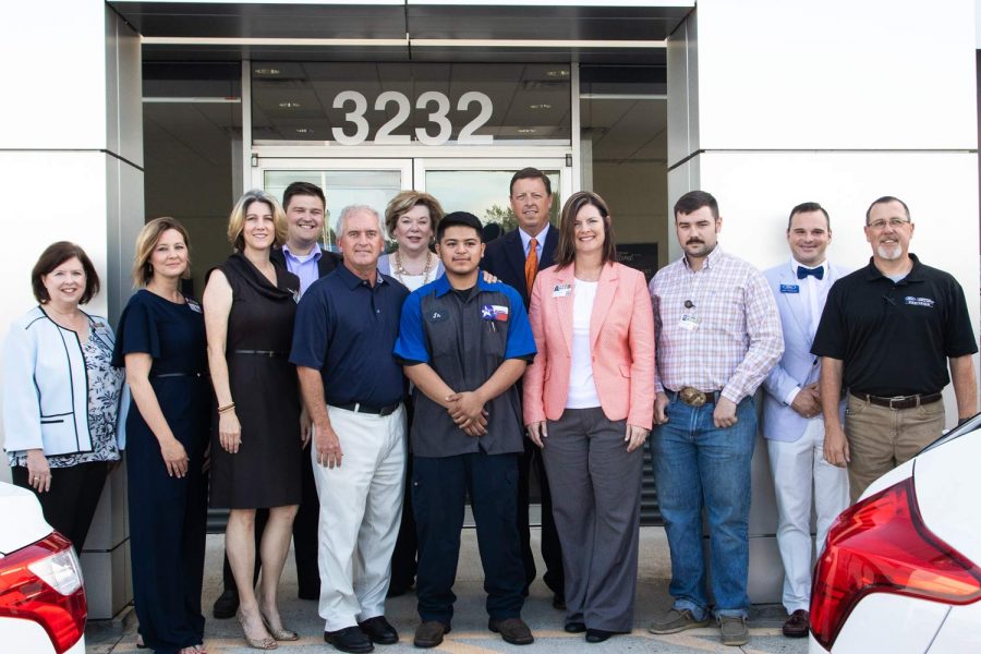 TISD and Ford representatives stand with graduate Alejandro Zarate after press conference