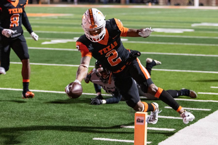 Senior runnig back Tracy Cooper reaches for the goal line to score a touchdown for Texas High in the third quarter against West Mesquite. The Tigers secured a play off birth with a 41-14 win.