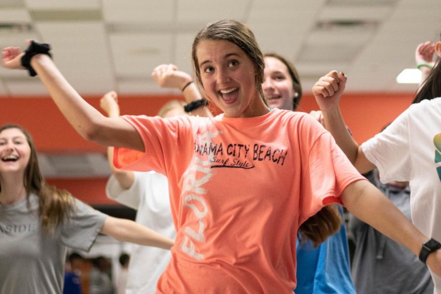 Sophomore Carrigan Brush dances to a Just Dance video during the Sock Hop. The event was held to raise funds to build a well in Uganda.