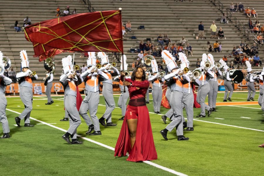 Junior Armani Griffie dances with her flag during halftime at Tiger Stadium. Color Guard performed alongside the Marching Band at football games during the 2019 season.