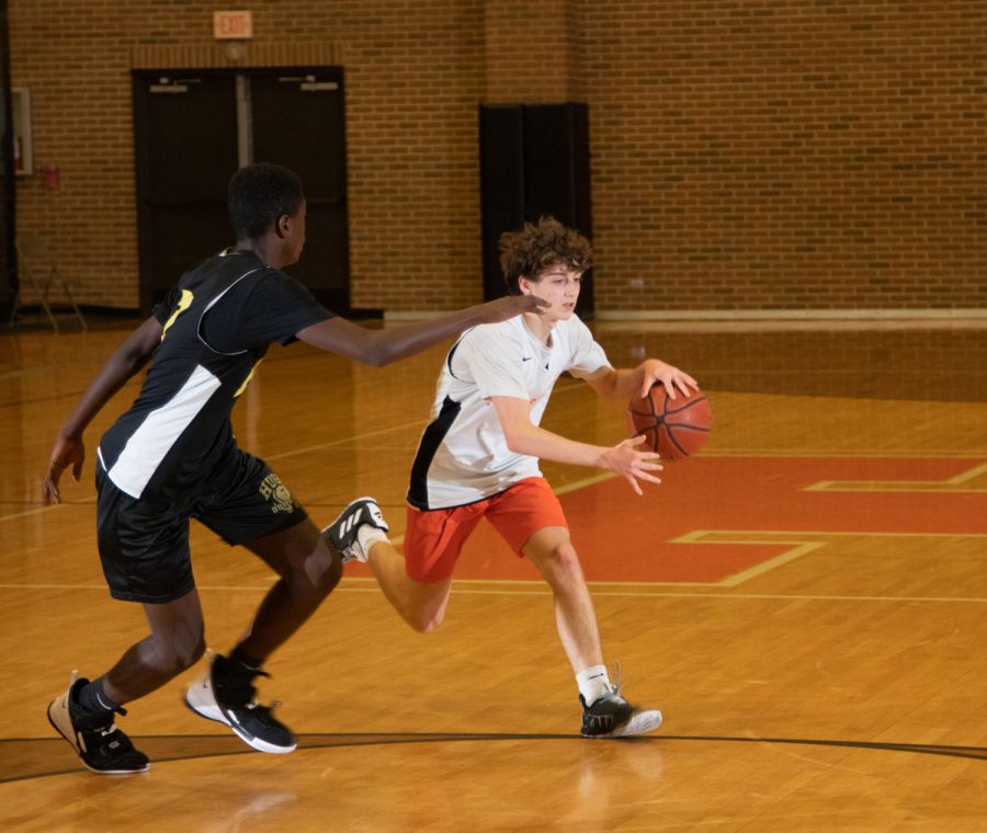 A Texas High School Varsity basketball player dribbles the ball toward the basket. The Texas High vs. Hugo scrimmage took place on November 14th. 