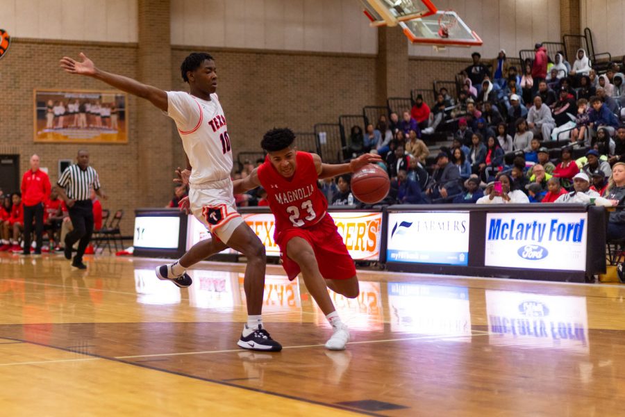 Texas High Varsity basketball player flanks the opponent. The Tigers took on the Magnolia Panthers December 20th, 2019 at the Texas High Tiger Center.