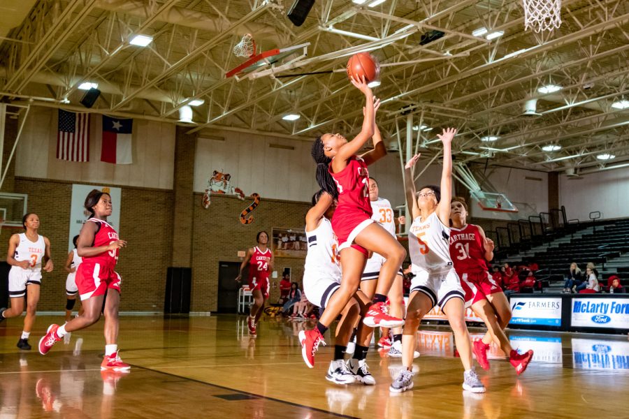 Texas+High+School+girl+freshman+basketball+players+attempt+to+defiant+the+opposing+basket.+The+Texas+High+vs.+Carthage+freshman+game+took+place+on+December+10th.+