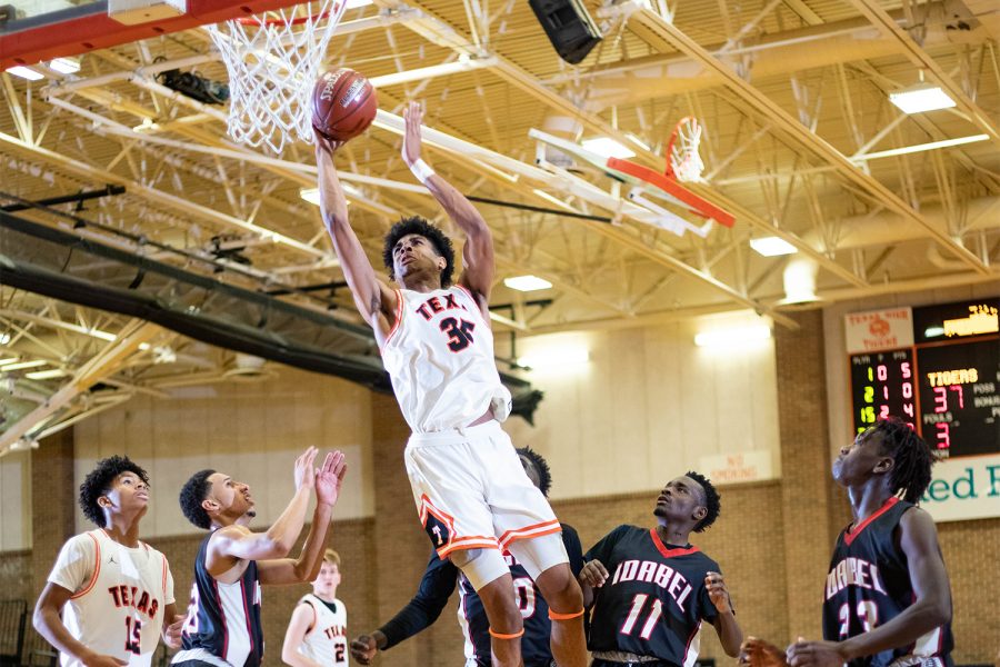 Senior CJ Kelley leaps towards the basketball goal in the varsity match-up against Idabel. The Tigers travel to Hugh Springs for the first round of the 2020 basketball playoffs.