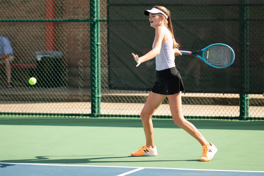 Freshman Lydia Lee plays tennis on the Texas High tennis court. Lee has played since she was three years old. 