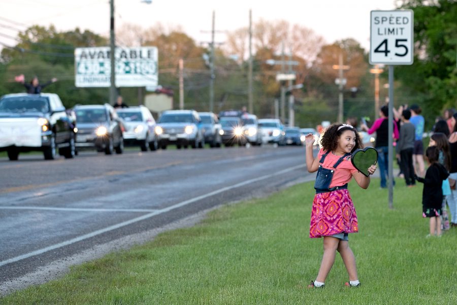 Nash Elementary third grade student Hannah Hamel smiles at her family as the teacher parade starts to pass Hannah’s location on April 15, 2020. Nash Elementary teachers coordinated with the city of Nash to produce the teacher parade so that teachers could reconnect with their students during the COVID-19 pandemic.