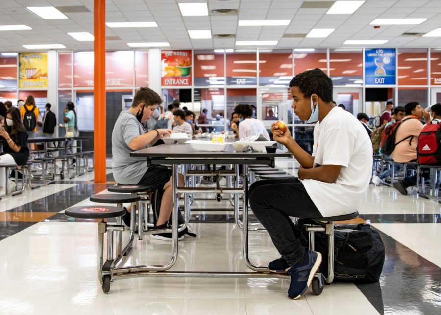 A student eats his lunch while socially distancing at the table. Texas High decided to add an additional fourth lunch to decrease the amount of people in the cafeteria at once. 