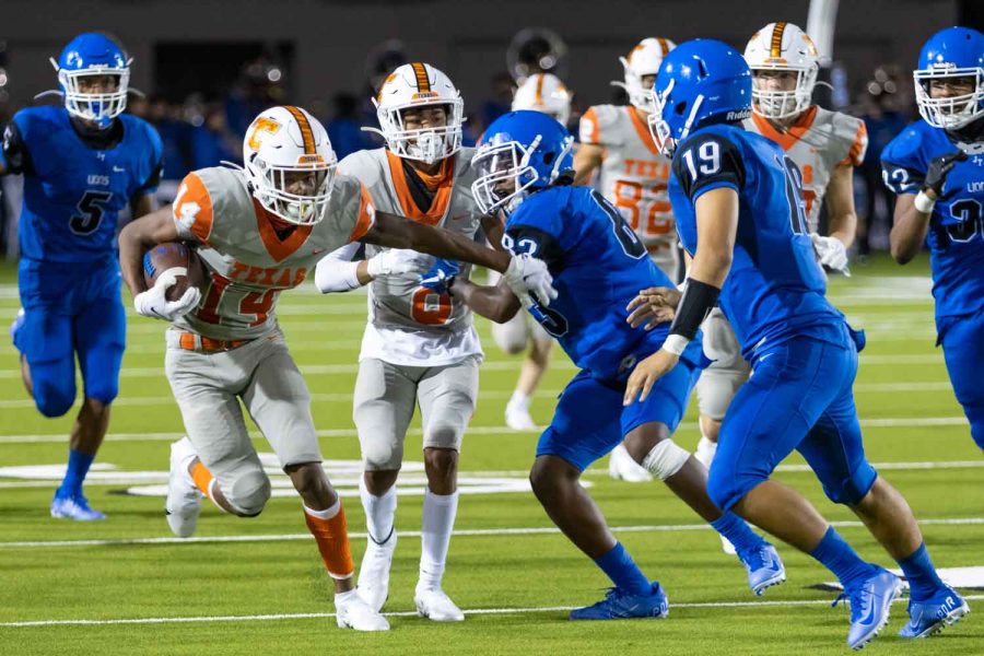 Wide receiver Tre Roberts protects the ball from the Tyler High School Lions on the run after a catch. Texas High School defeated Tyler High School 41-21 Thursday, September 24th, at Rose Stadium.