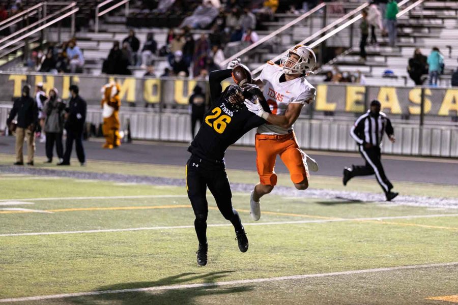 Junior Blake Rogers leaps in the air fighting over the ball with a Mount Pleasant Receiver. The Tigers ended up defeating Mount Pleasant.