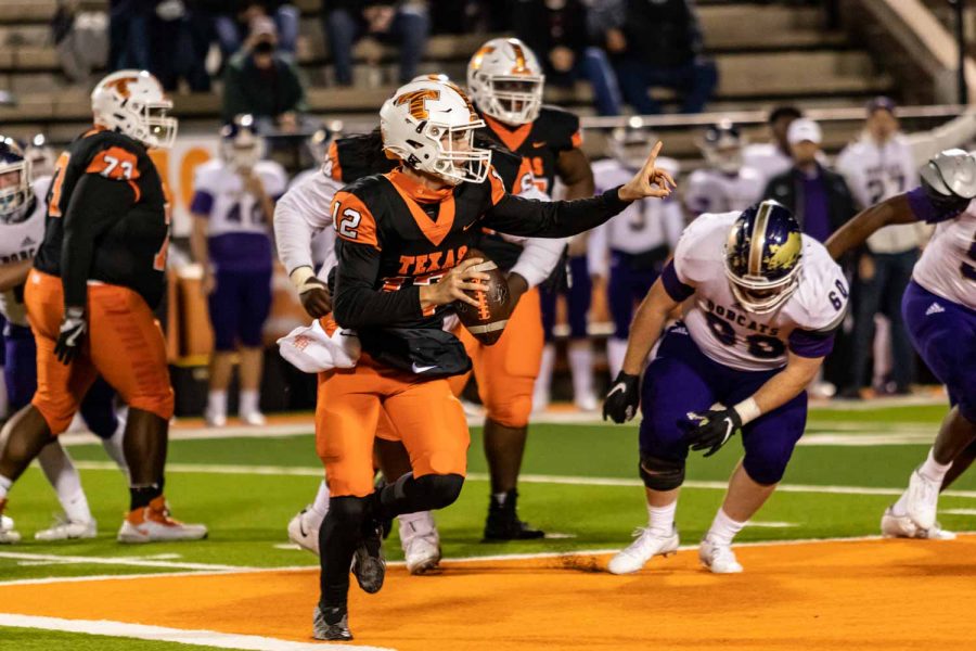 Quarterback Brayson McHenry prepares his throw, looking for a fellow teammate to pass it to. The Tigers demolished the Hallsville Bobcats 56-17.