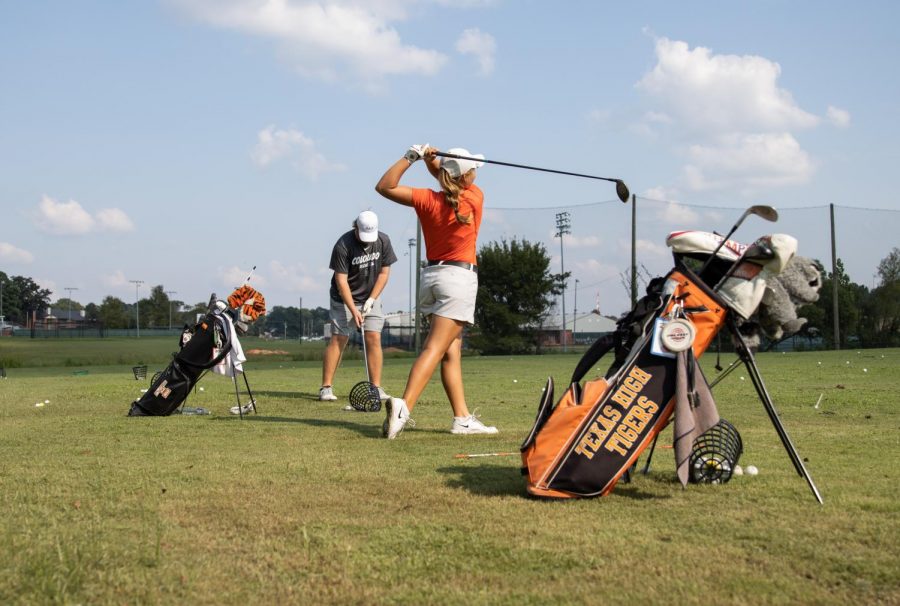 Senior Graci Henard practices her drives during practice. Henard has faced the trials of applying to college during a pandemic. 