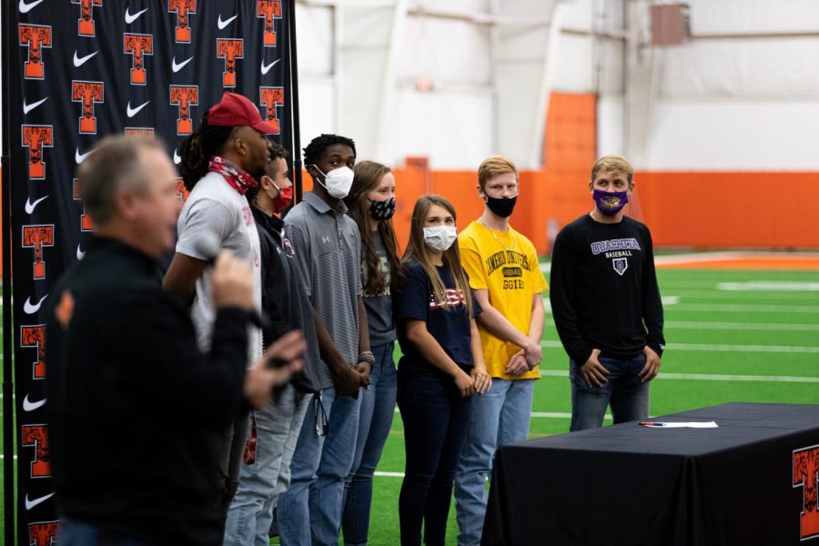 The seven signees of the fall 2020 signing day stand together as Athletic Director Gerry Stanford gives words of motivation to the crowd. Ben Depriest, Trey Lavendar, Graci Henard, Mollie Johnson, Rian Cellers, Jackson Halter and Clayton Smith all committed to their colleges on Nov. 11.