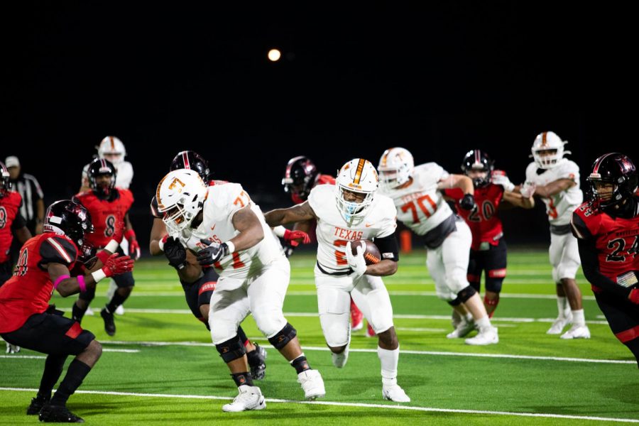 Junior Braylon Stewart breaks through the Marshall defensive line. Stewart led the team to a 28-0 win providing three touchdowns and 254 yards rushing. 