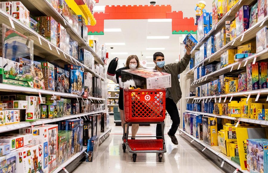 Two Black Friday shoppers rampage through an aisle at Target. This year, if the customers are not shopping from home, theyre expected to wear masks upon entry. 