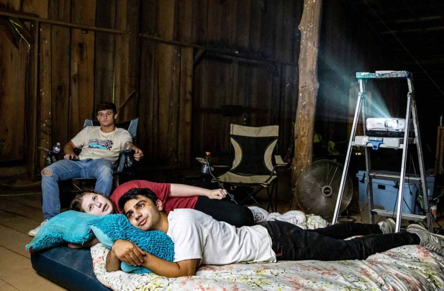  A group of friends gathers in an old barn to watch a classic horror film on a projector. This year, teenagers celebrated Halloween in numerous creative ways due to COVID-19 restrictions. 