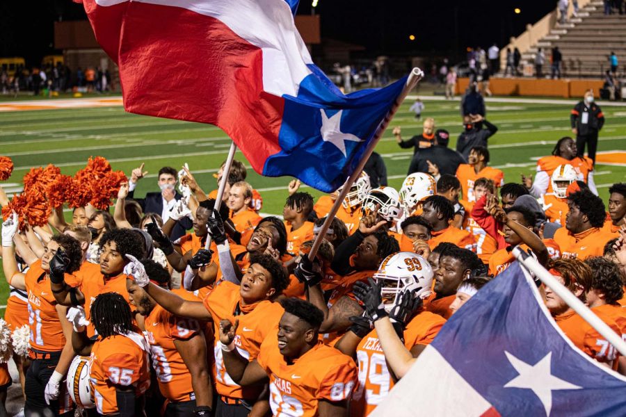 The Texas High Tigers celebrate a victory by singing the school song together. The Texas Tigers won against the Forney Jackrabbits on October ninth of twenty-twenty .
