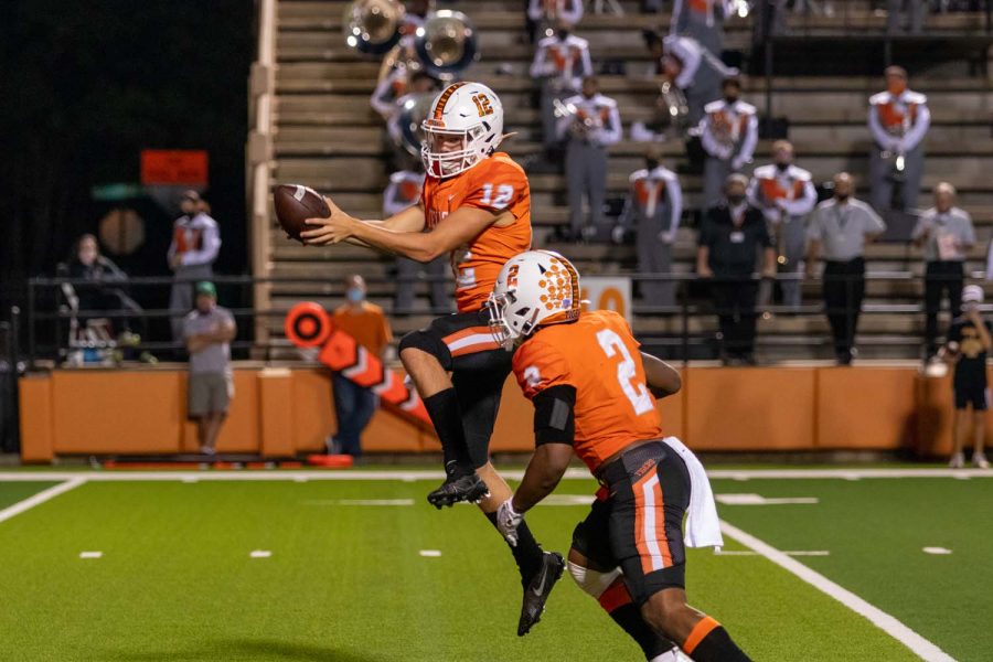 Quarterback Brayson McHenry captures the snap in preparation to pass it on to his fellow team mate, Braylon Stewart at the Texas High Homecoming football game. The Texas High Tigers solidified the win against the Forney Jackrabbits, 49-10 on October 9, 2020.