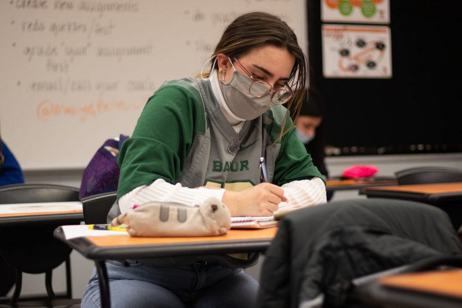 Junior Beth Dietze takes notes during an in-class lecture. Being diagnosed with dyslexia ever since she was young, Dietze is faced with challenges on a daily basis.