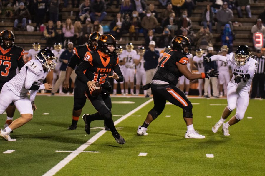 Quarterback Brayson McHenry prepares to pass the ball during the first play off game. Texas High won the first round with a final score of 37-7.