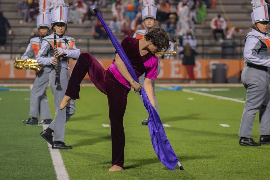 Senior Connor Corbett poses during his part in the performance by the Tiger band and color guard. Corbett spends his Friday nights performing for both.