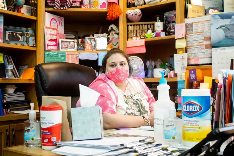 Math teacher Cathryn Diaz sits behind her desk surrounded by disinfectants. Diaz recently battled COVID-19 while also fighting cancer. 