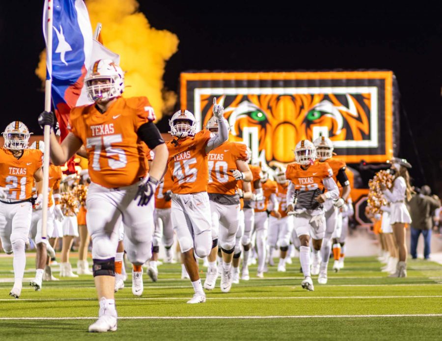 The Texas High Tigers storm the field before kickoff. Texas High played against Whitehouse at Tiger Stadium at Grim Park.