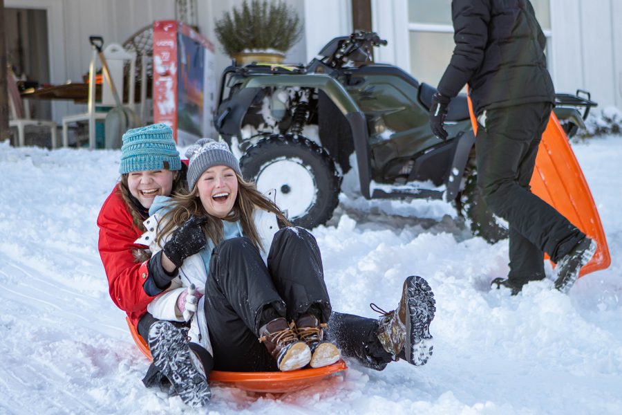 Seniors Malley Wallace and Endsley Norman sled down a snowy hill on Feb. 15. While the cold weather has proved to be fun, some people struggle with knowing how to properly tackle the snow. 