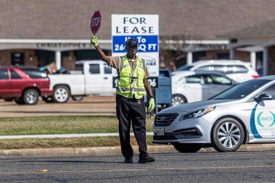 A TISD guard directs after school school traffic. The TISD traffic guards work shifts before and after school.
