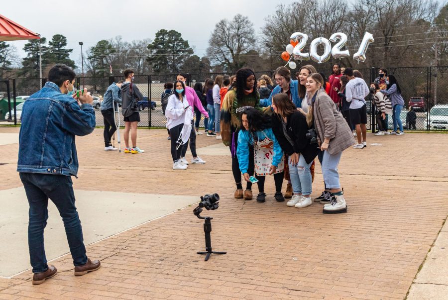 Senior Assad Malik takes a disposable picture during the 2021 bacon fry. The bacon fry, though pushed back due to Covid-19, was still put on.
