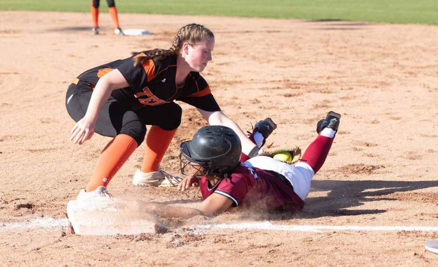 Senior+Mollie+Johnson+gets+a+player+from+the+opposing+team+out+as+she+slides+to+first+base.+Johnson+is+the+only+senior+returning+to+the+Lady+Tigers+softball+team.+