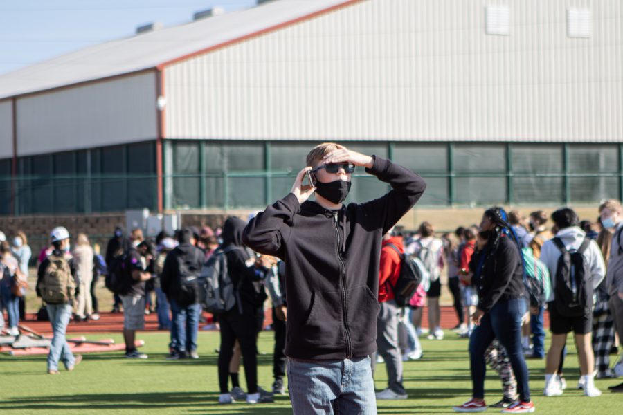 Overwhelmed by the chaos, a students phones a family member to alert them of the bomb threat on the school. Since January, three bomb threats have been made on THS. 