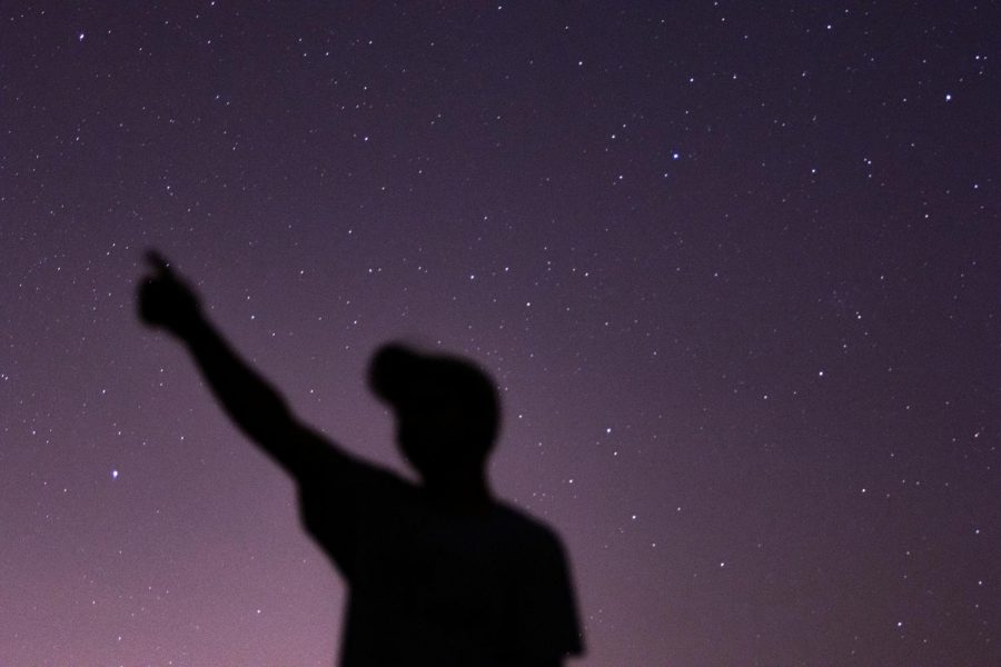 A senior points at his constellation during a starry night. Theres many events to look forward to in 2021, including a few meteor showers. 