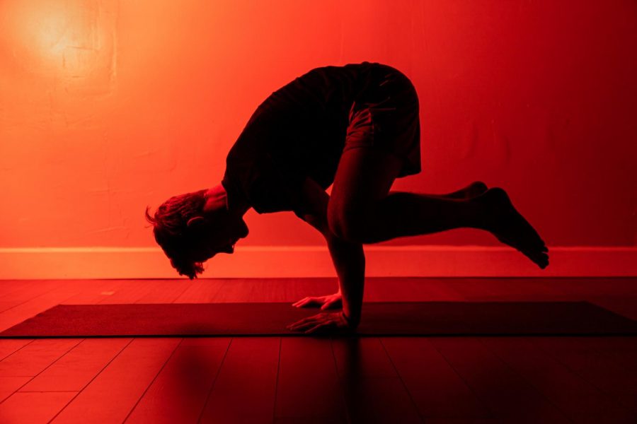 Senior Trey Lavender practices a yoga position prior to his regular class. An influx of males joined the class this upcoming year. 