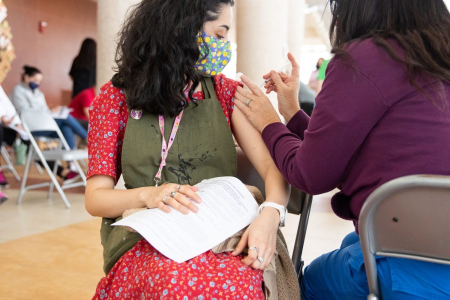 A teacher receives her COVID-19 vaccine in the Sullivan Performing Arts Center. About 275 staff members received the one-time Johnson & Johnson vaccine. 