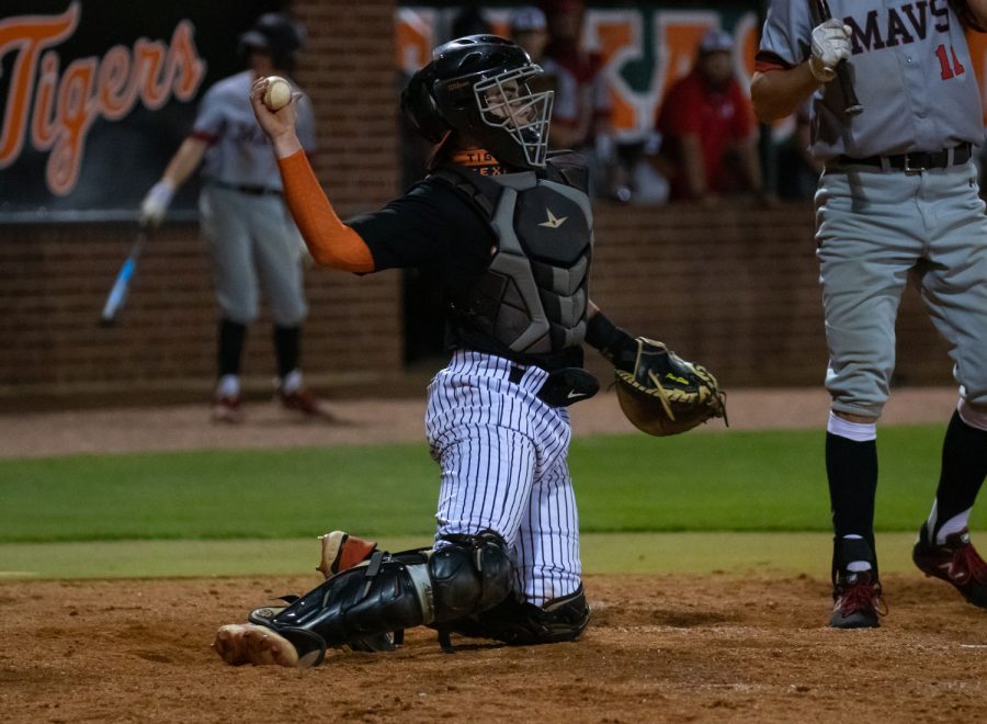 Catcher Jackson Halter launches a ball back to the pitchers mound during a home game against the Marshall Mavericks. The Tigers lost 4-3.