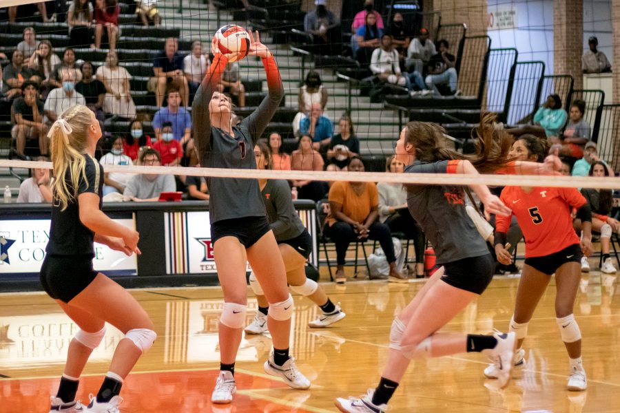 Junior Bella Cherry sets the ball up for senior Jaycee Kennedy to attack during the game against Pleasant Grove Aug. 24 in Tiger Center.